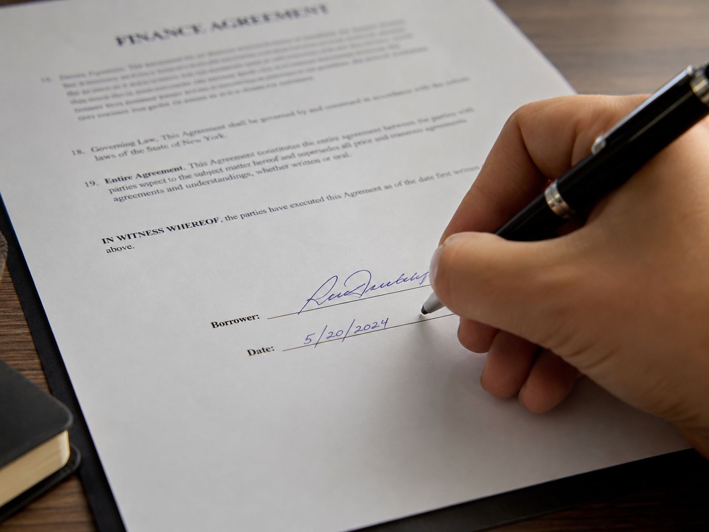 A Director reviewing a signed loan agreement